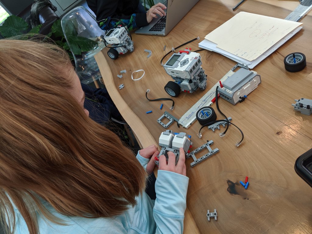 young girl working on robot