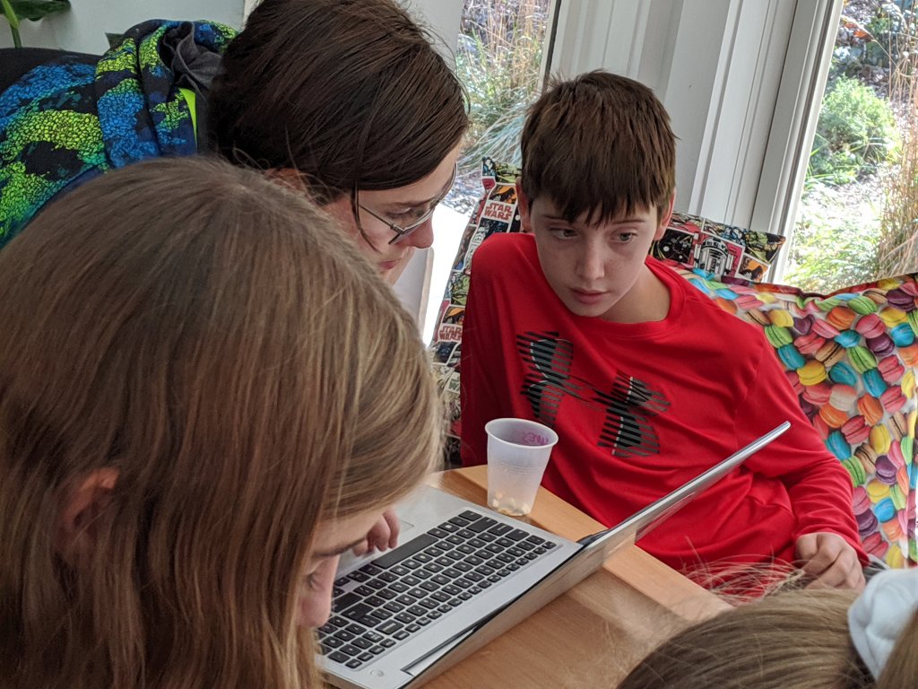 three kids working on code